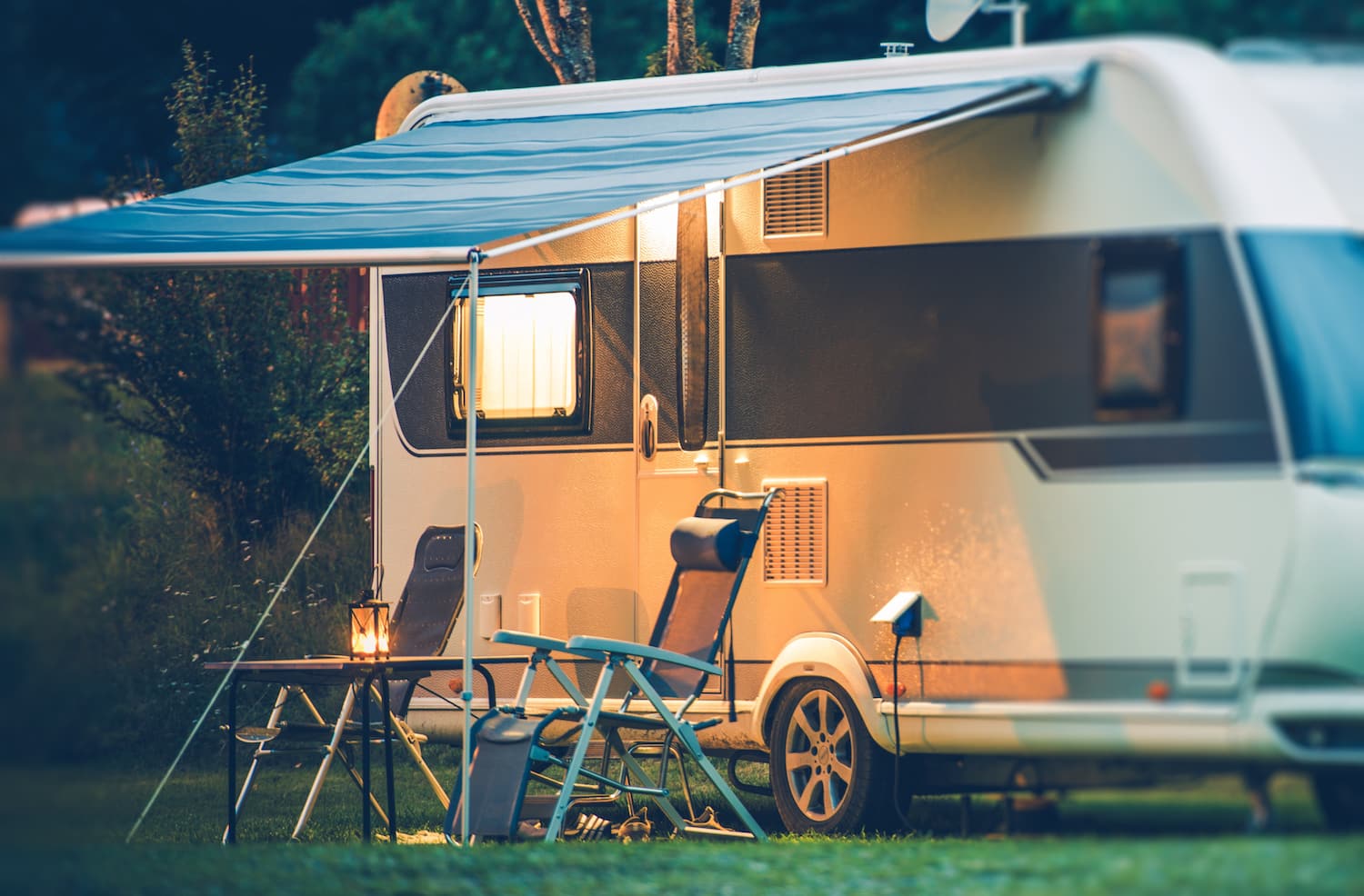 Travel Trailer Caravaning. RV Park Camping at Night.