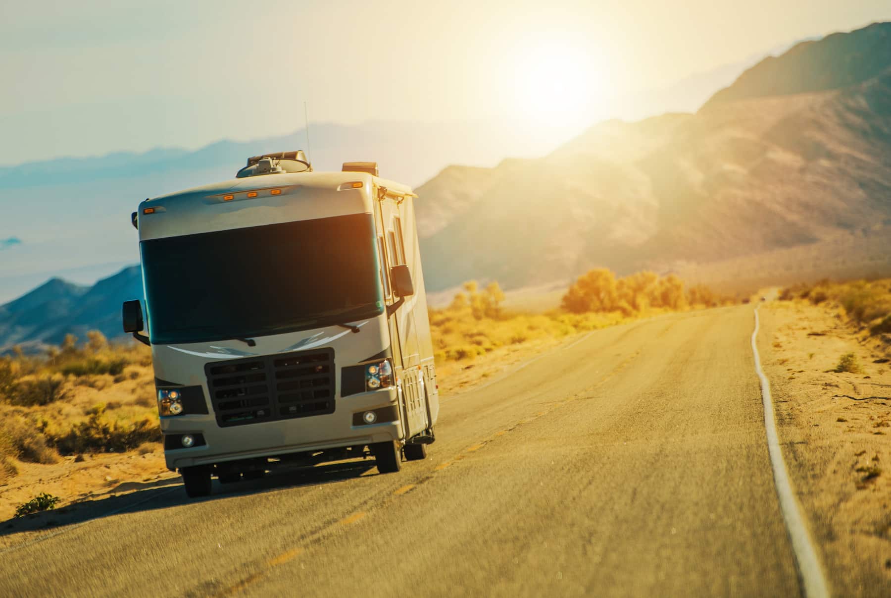 Motorhome on the Desert Road Somewhere in the Southern California Mojave Desert. Class A Gasoline Engine Motorcoach. United States of America. American RVing. (Motorhome on the Desert Road Somewhere in the Southern California Mojave Desert. Class A Ga